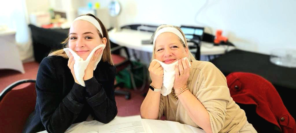 Two women with towelettes in their hands  in a workshop setting